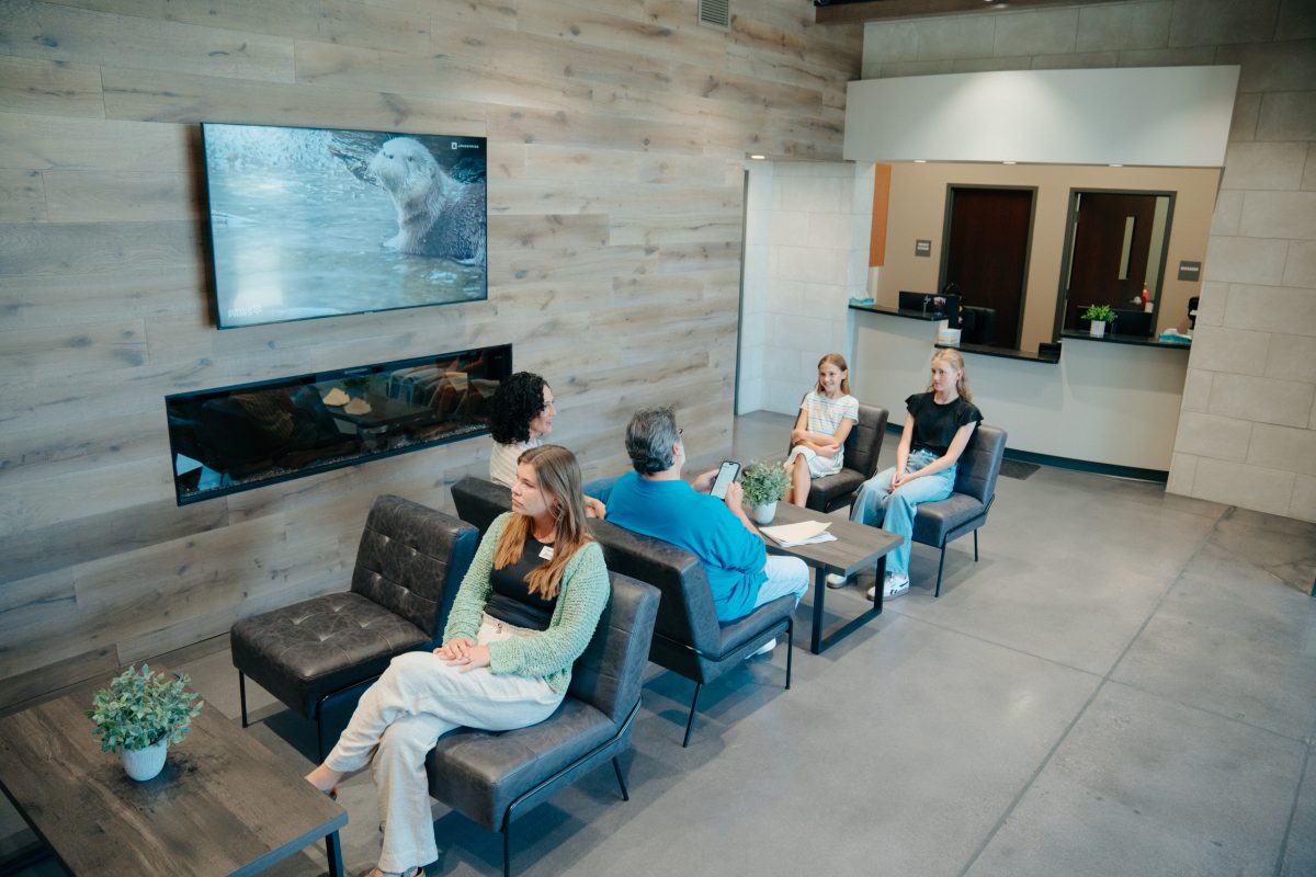 Five patients sit in an AFC urgent care waiting room.